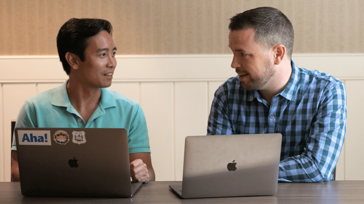 Two men working at laptops